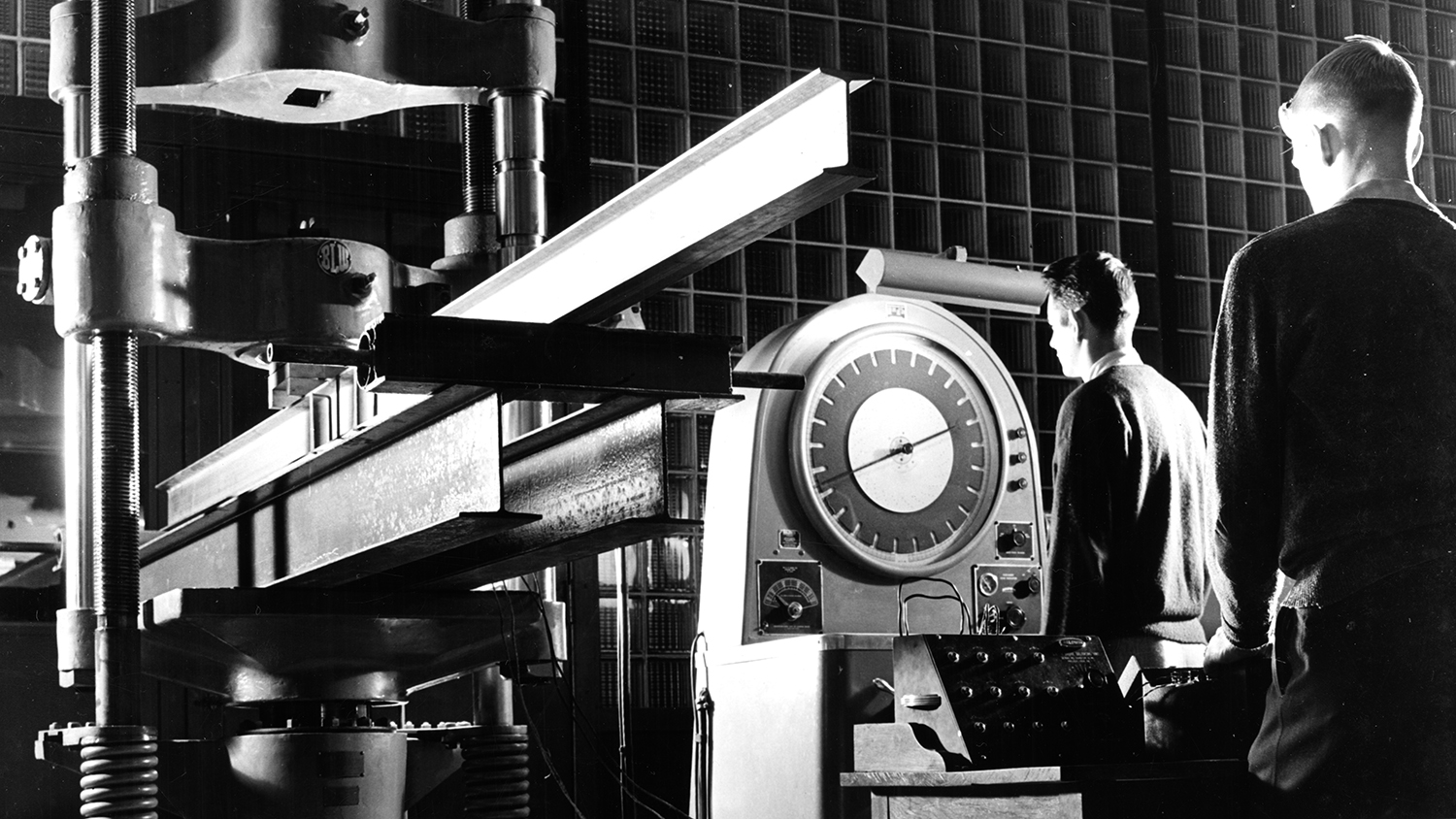 Archival black and white photo of two NC&#160;State staff members working in an early lab.