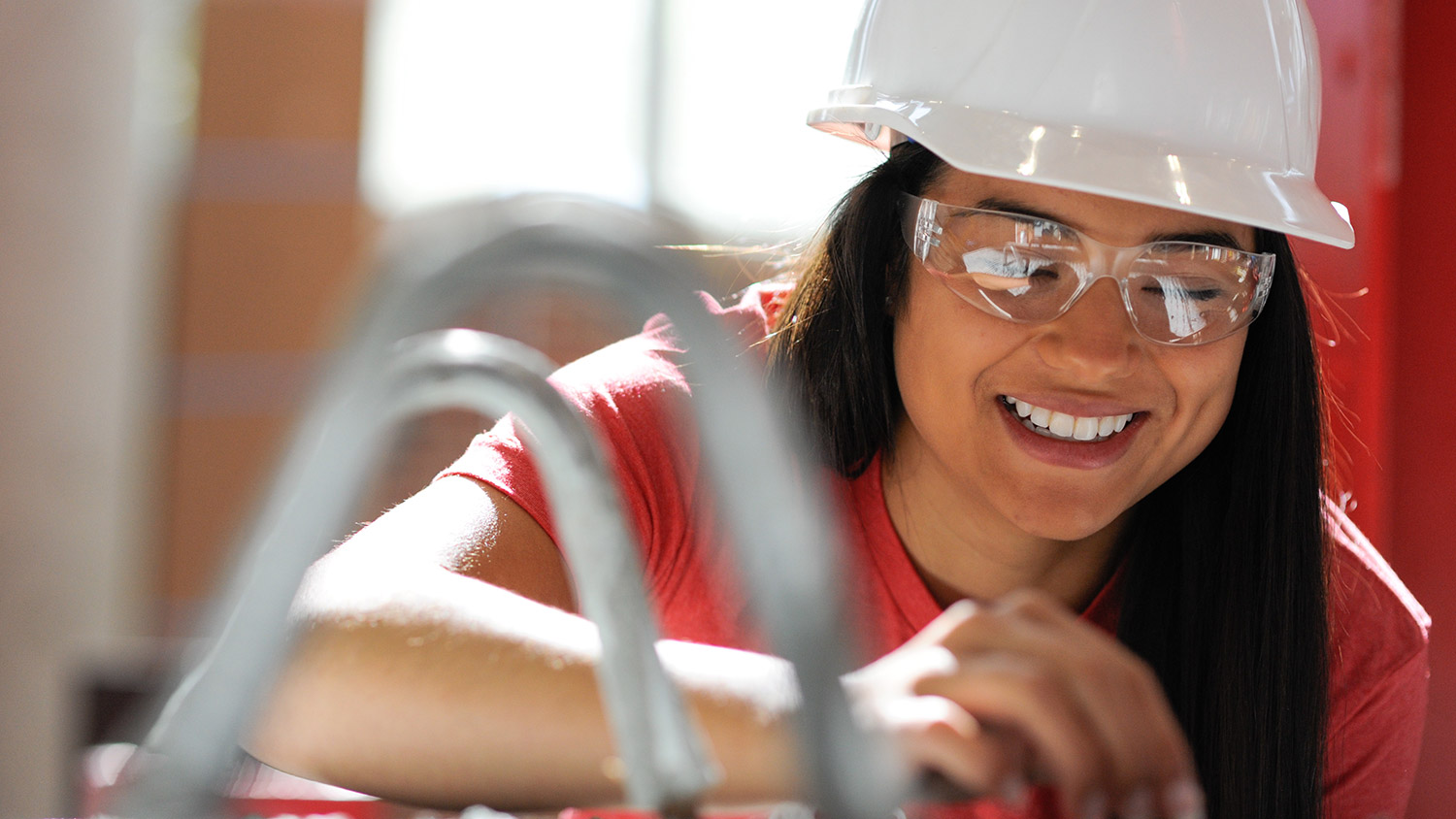 Female student wearing a white hard-hat .