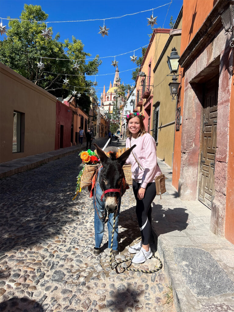 Savannah Tabor poses with a donkey during a trip to Mexico.