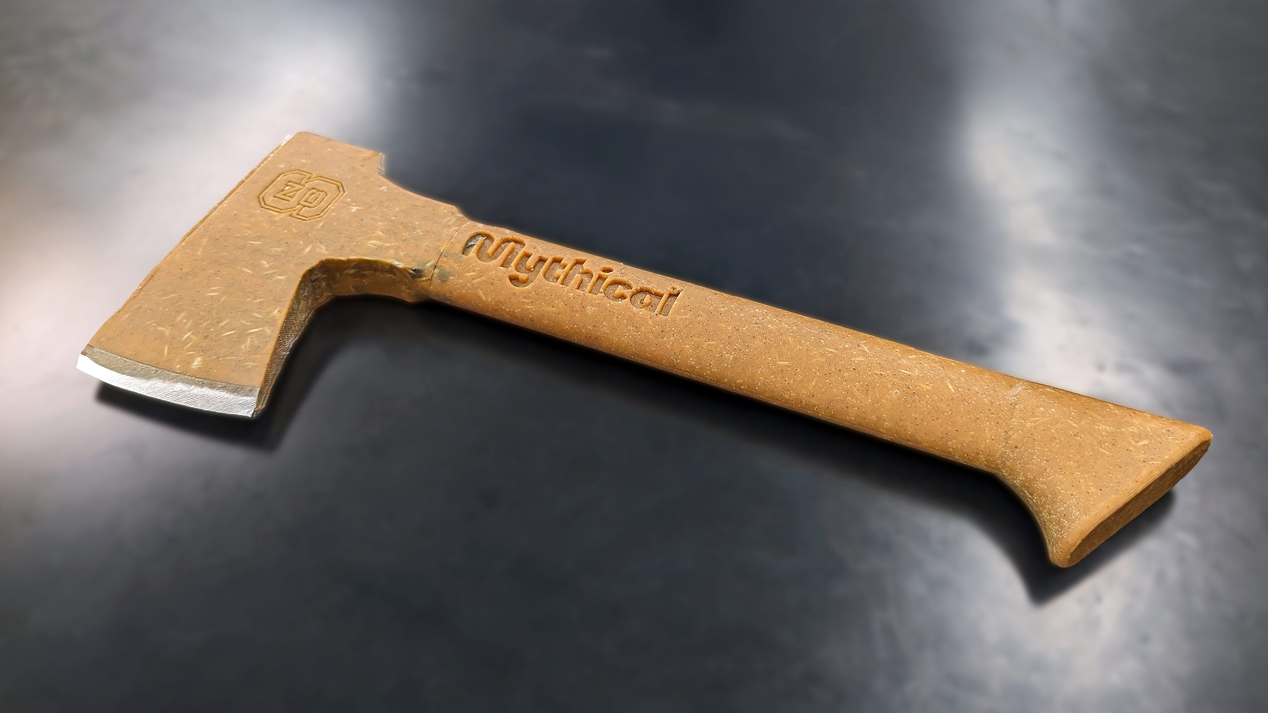 a light brown axe made out of peanut butter lying on a dark grey table