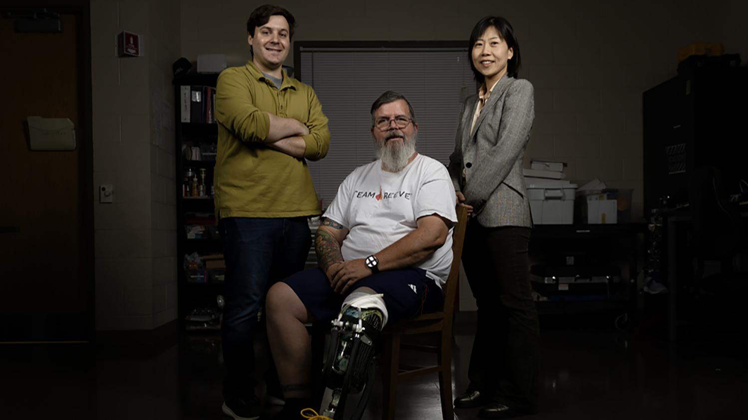 He “Helen” Huang (right) develops next-generation prosthetics, which is a team effort. Postdoctoral researcher Josh Tacca (left) is leading a clinical study on prosthetic ankles and works with study participants like Greg Phillips (center) to test the technology created in the lab. (photo by Alyssa LaFaro)