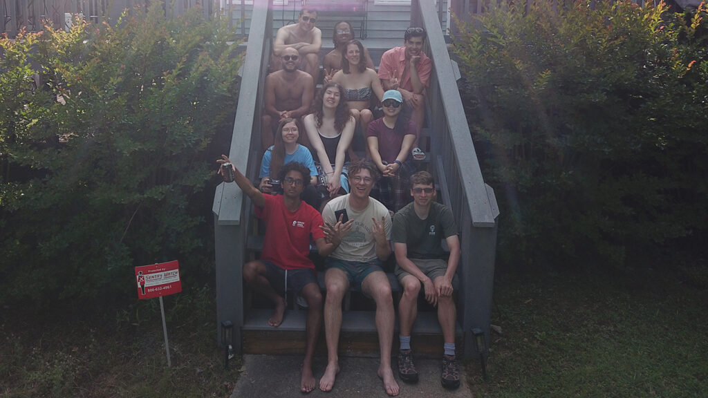 Emily Duan, second row right, poses with with friends on a set of stairs at a weekend lake house.