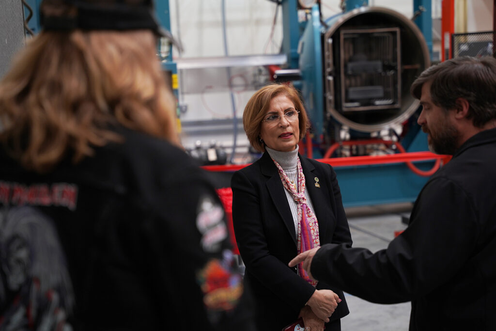 Afsaneh Rabiei, center, speaks to a group of visitors at the Hot Press Furnance facility.