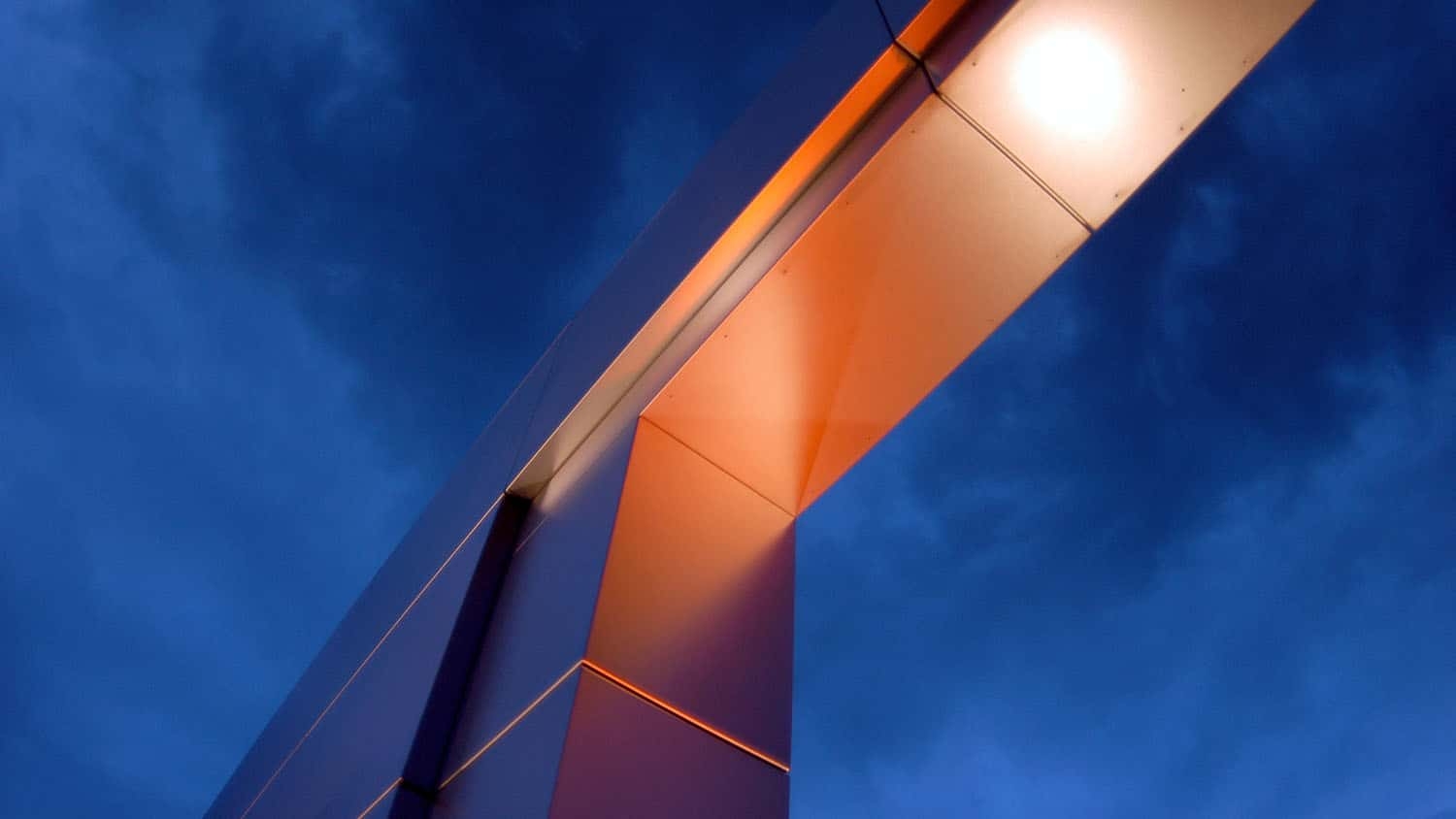 NC State metal gateway sculpture silhouetted against the sky