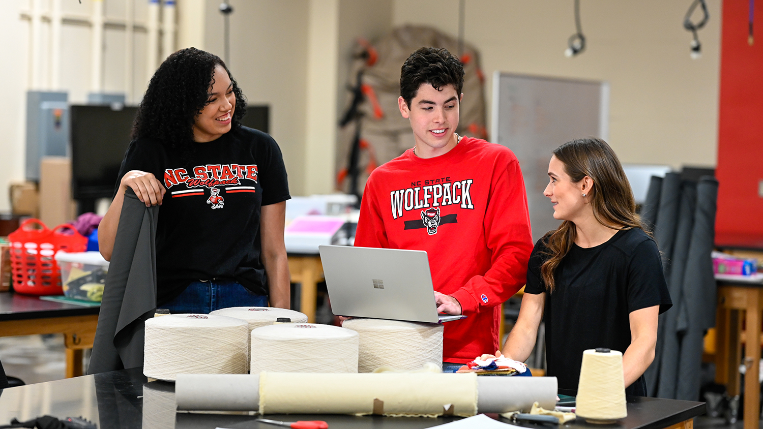 Three students working together in a lab.