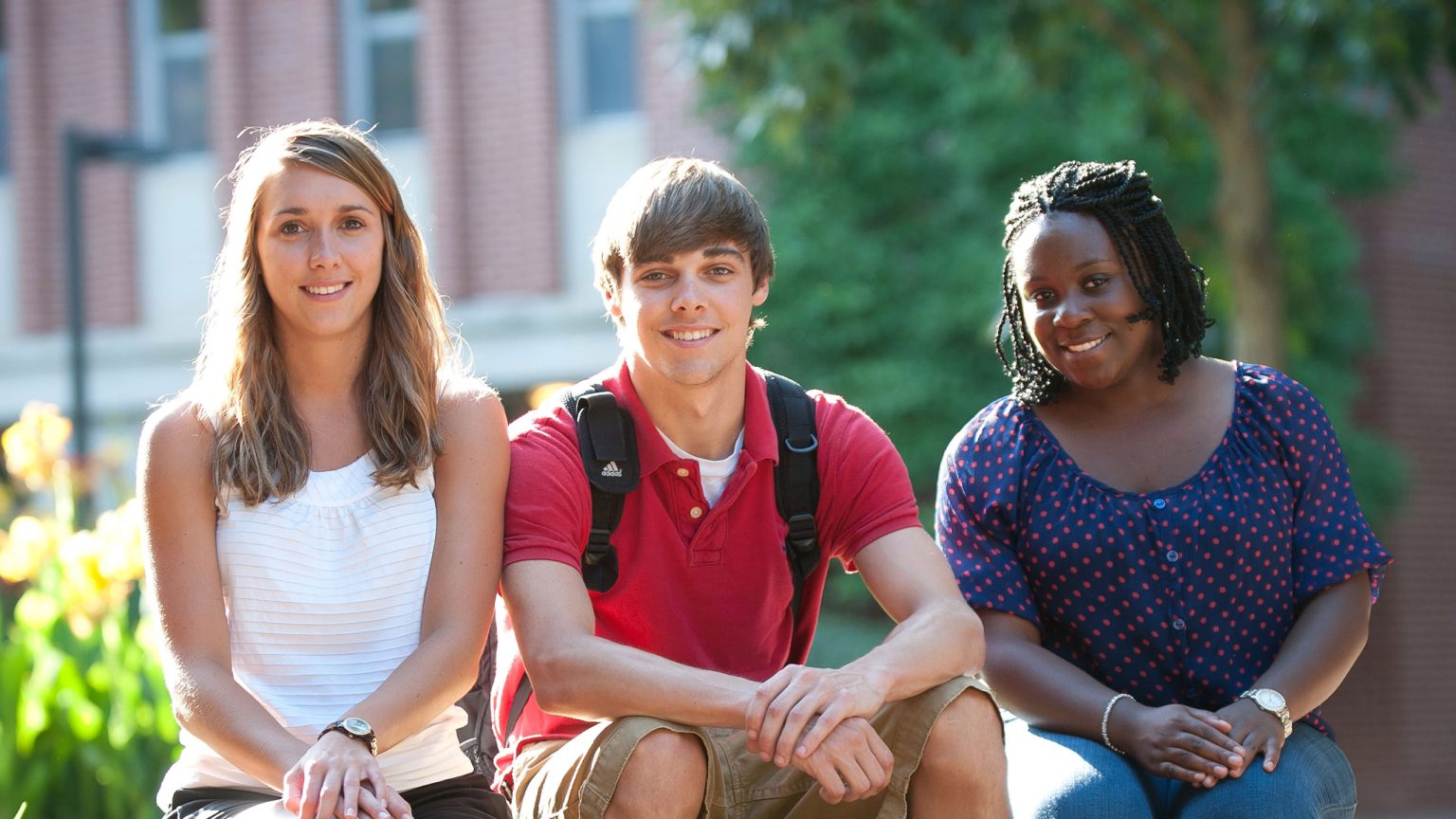 Three students completing their admissions to the NC State Operations Research Program