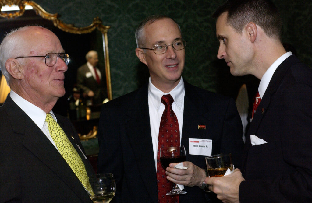 Ross W. Lampe Sr., left, and Ross W. Lampe Jr., center, with an unidentified person at a 2004 event.