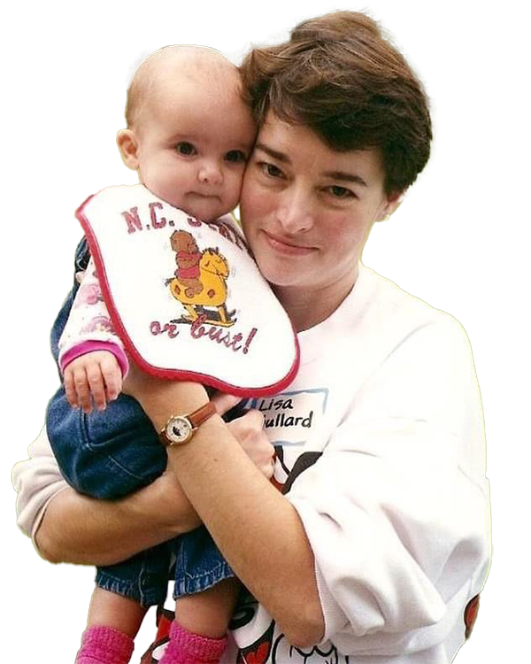 Meredith Martinez as infant held by her mother. Meredith is wearing an NC State bib.