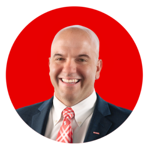 Jim Pfaendter profile photo on a red circular background.
