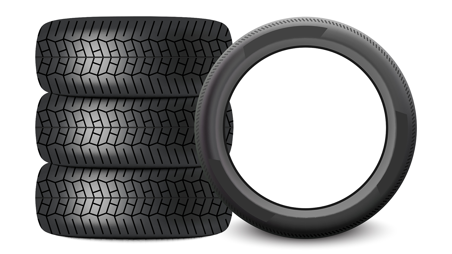 Image of three car tires stacked and one standing on its side profile next to them.