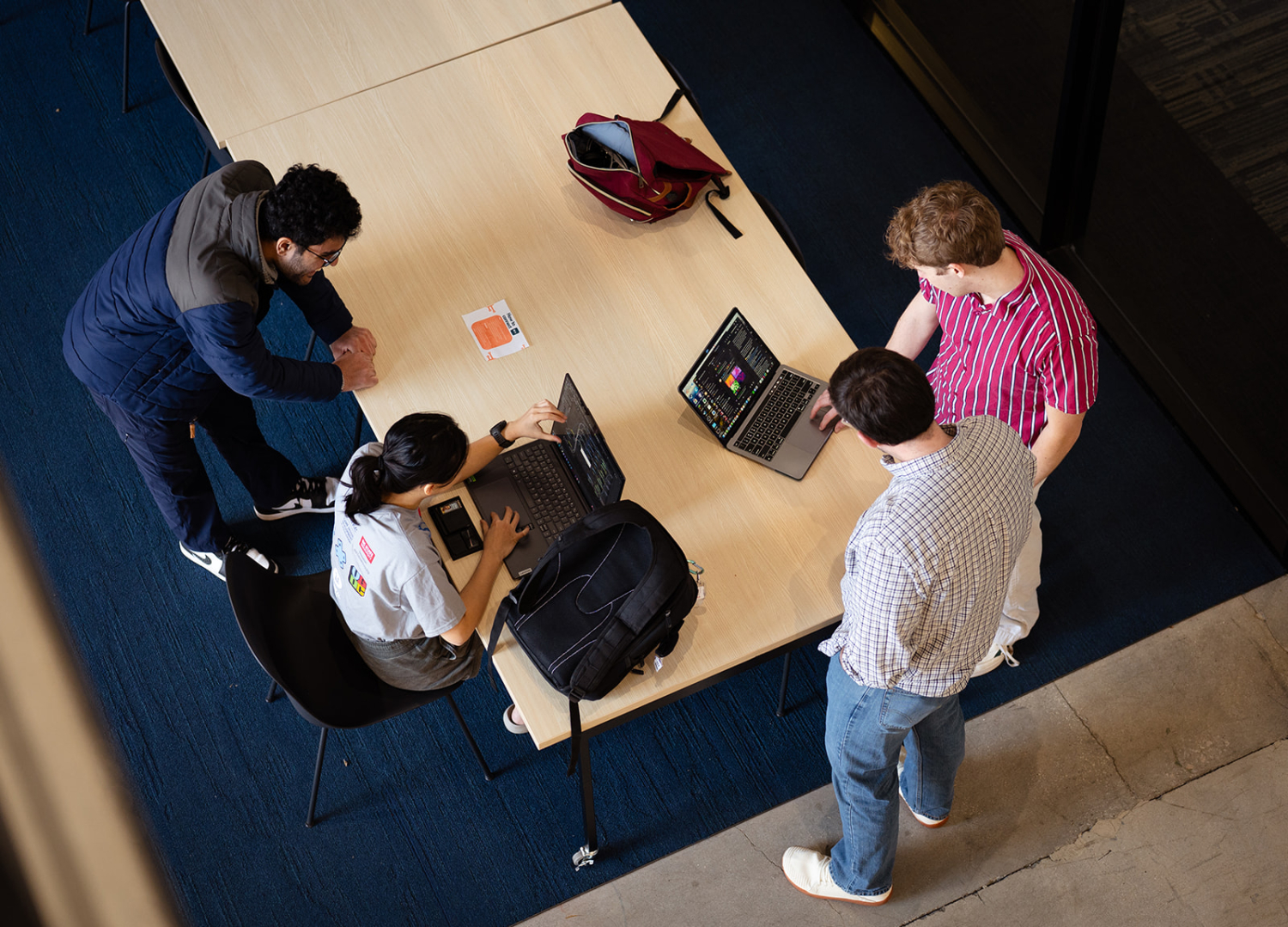 Group of students working around a table.