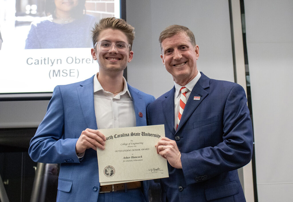 Asher Hancock, left, receives award from Jerome Lavelle.