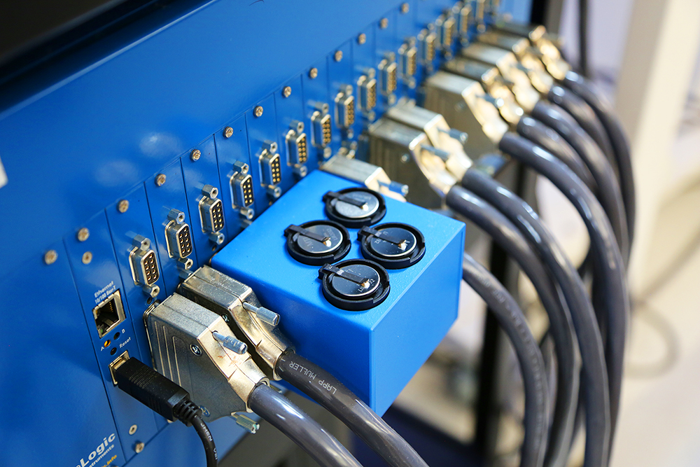image of set of CR format batteries on blue charging unit