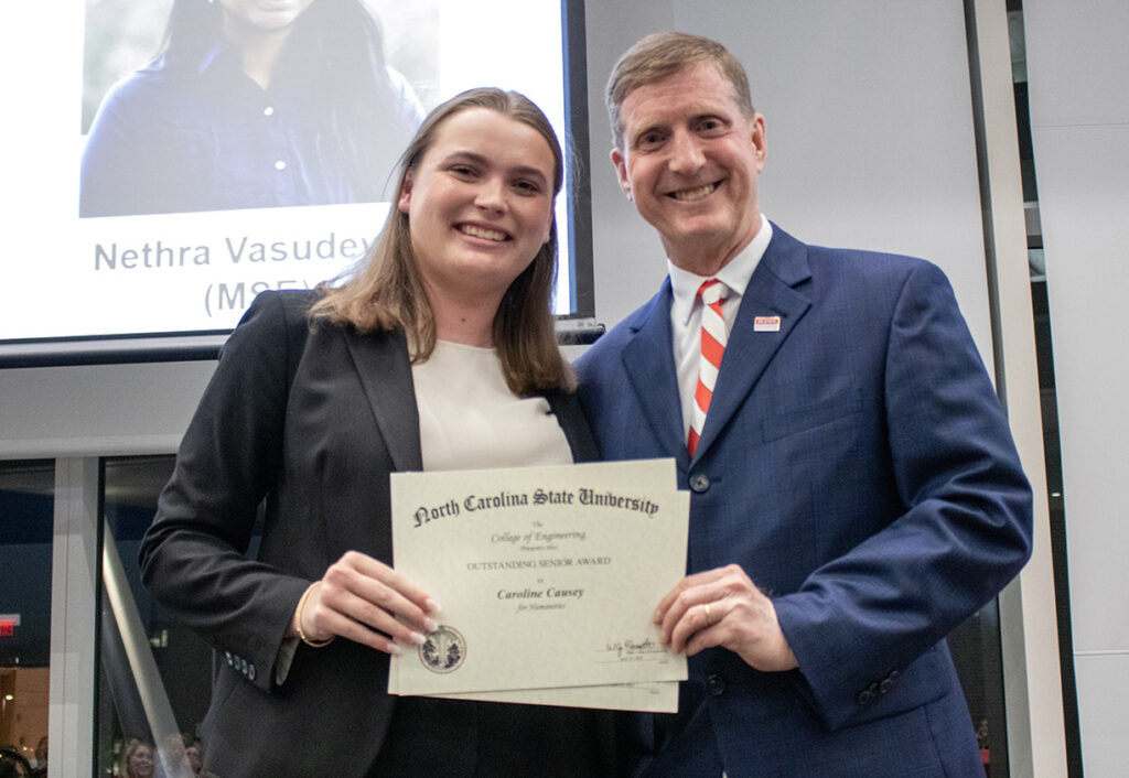 Caroline Causey, left, receives award from Jerome Lavelle.