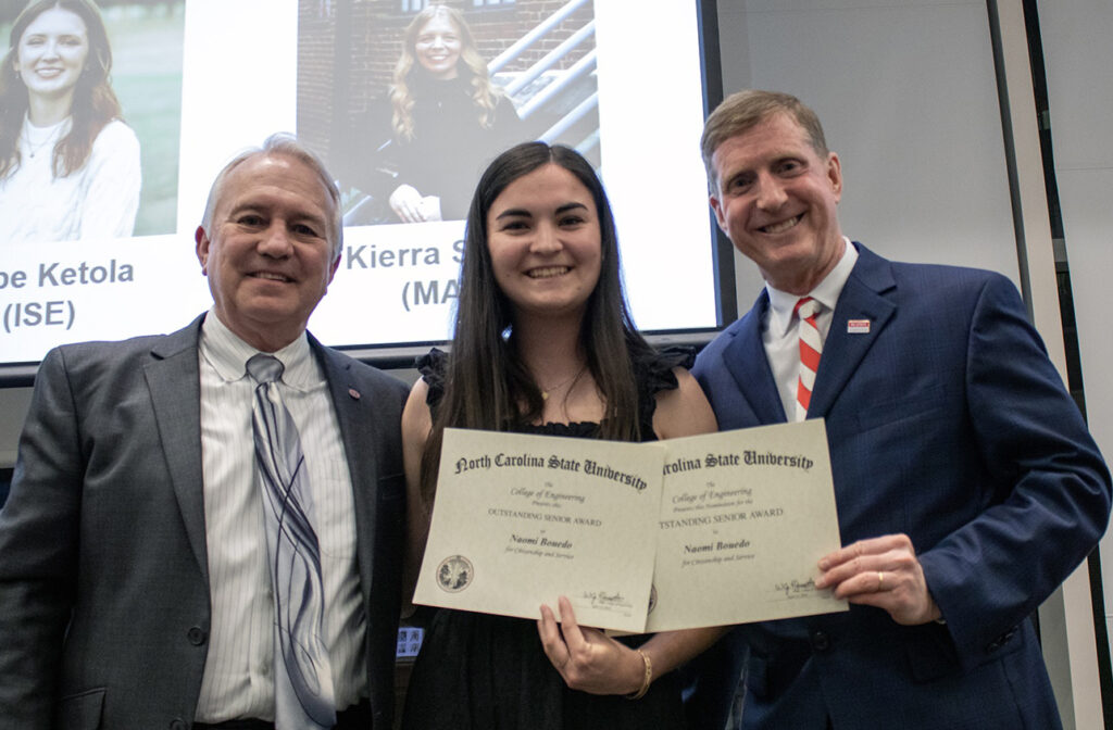Naomi Bouedo, middle, receives award from David Parish and Jerome Lavelle.