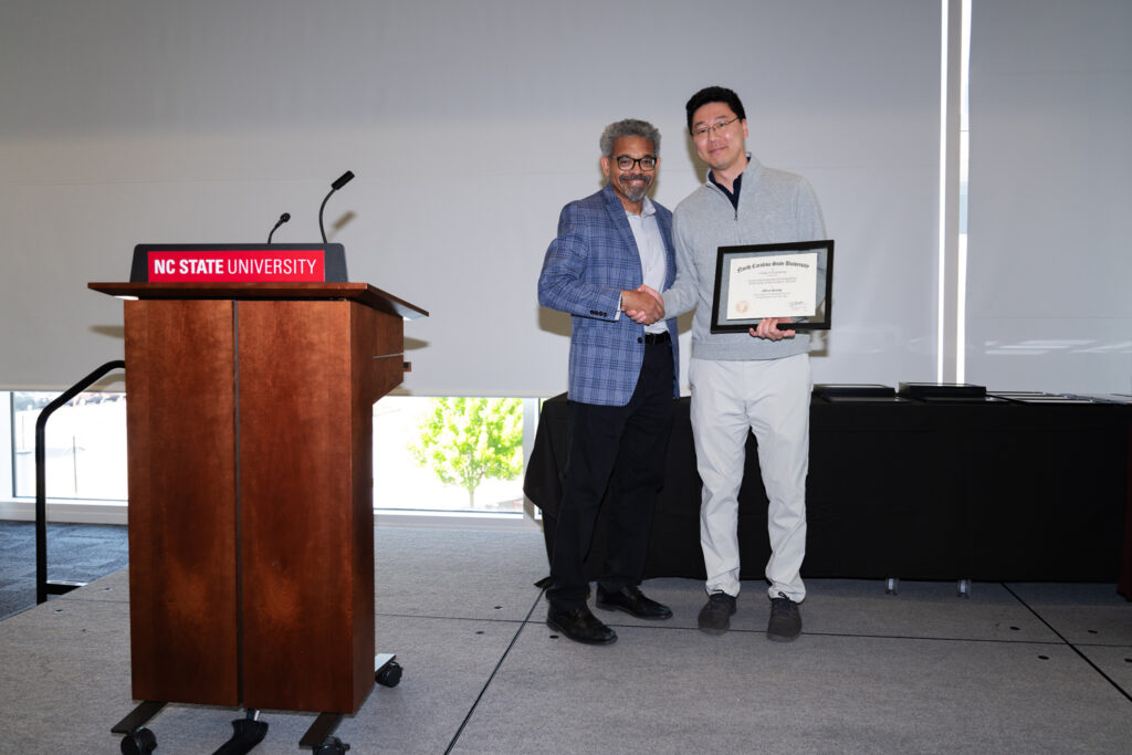Albert Keung, right, receives award from Joel Ducoste.