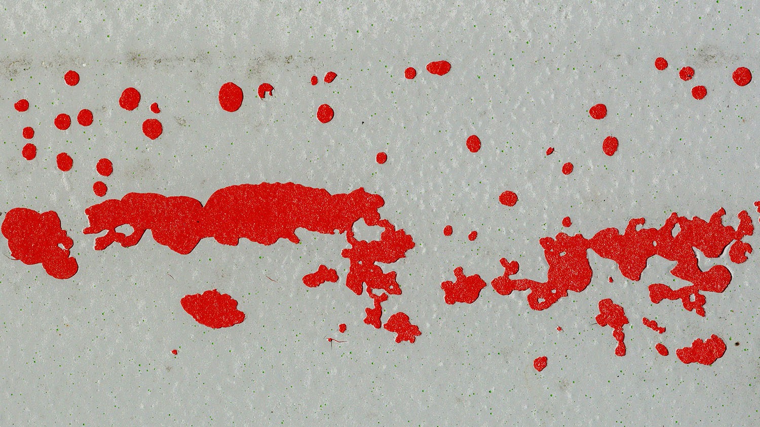 red stains are spattered across a white background