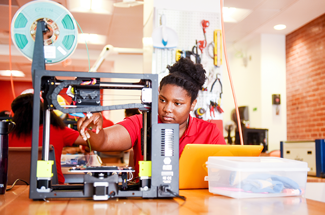 Freshman works in makerspace.