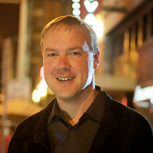 younger man wearing a dark shirt
