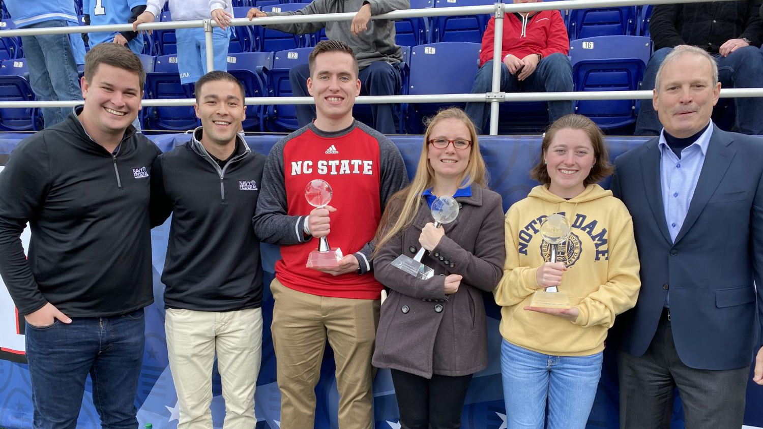 From left to right: Nick Carey, Account Coordinator, Bespoke Sports &amp; Entertainment; Ryan Milroy, Bespoke Sports &amp; Entertainment; Cadet Charles Blum, NC State Air Force ROTC; MIDN Jennifer Fillebrown, Florida, Navy ROTC; Cadet Nicole Butler, Notre Dame, Army ROTC; and Dietrich Kuhlmann, Senior Vice President of Branch Operations, Navy Federal Credit Union. (Photo: courtesy of Navy Federal Credit Union)