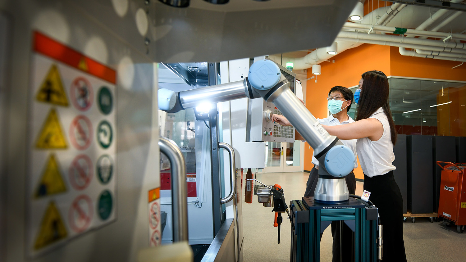 Two students working on a industrial device.