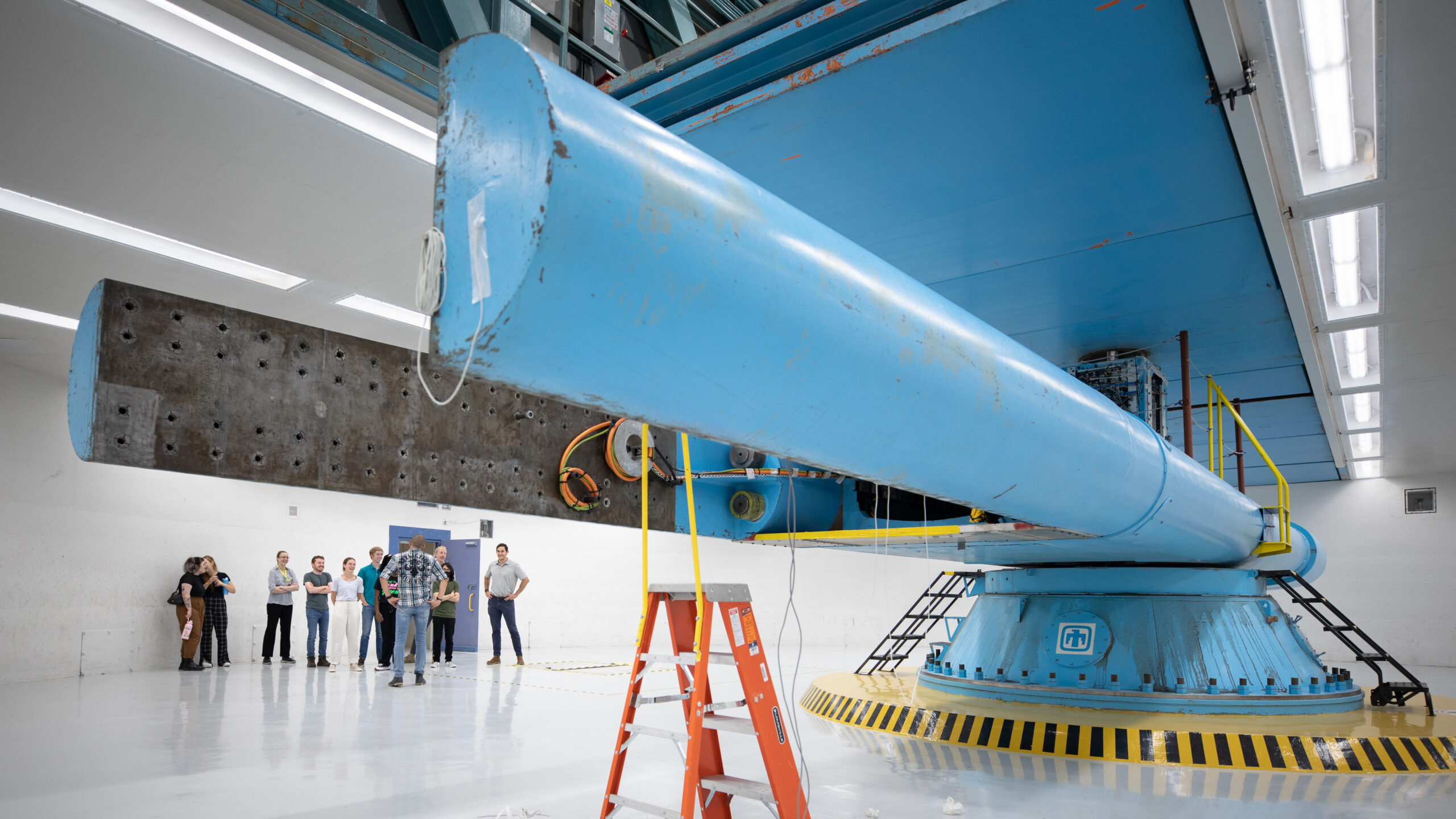 Student interns with CINT for the summer are introduced to Sandia’s Superfuge by test operations engineer Orlando Abeyta during a tour on Thursday, June 17, 2022.