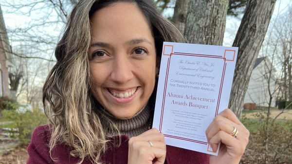 Ashly Cabas holds her young alumni announcement.