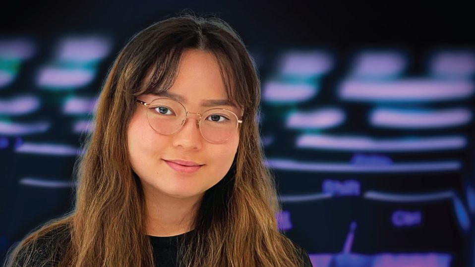 Emily Fang in front of a black and violet blurred background.