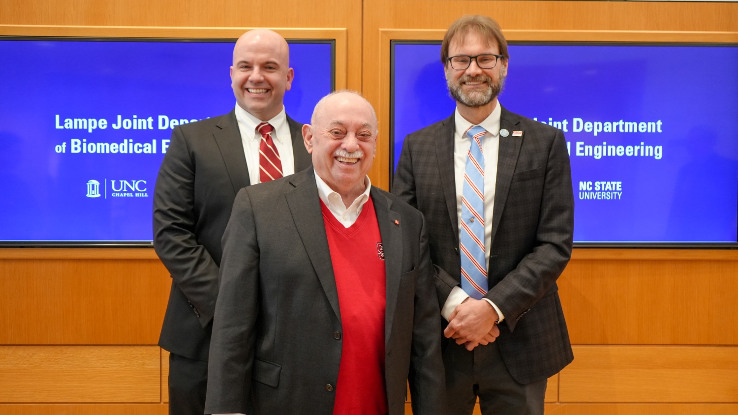 Jim Pfaendtner, the Louis Martin-Vega Dean of the College of Engineering, head of the Lampe Joint Department of Biomedical Engineering Paul Dayton and retired College of Engineering dean Louis Martin-Vega celebrated the generosity of Ross Lampe during an announcement to the faculty.