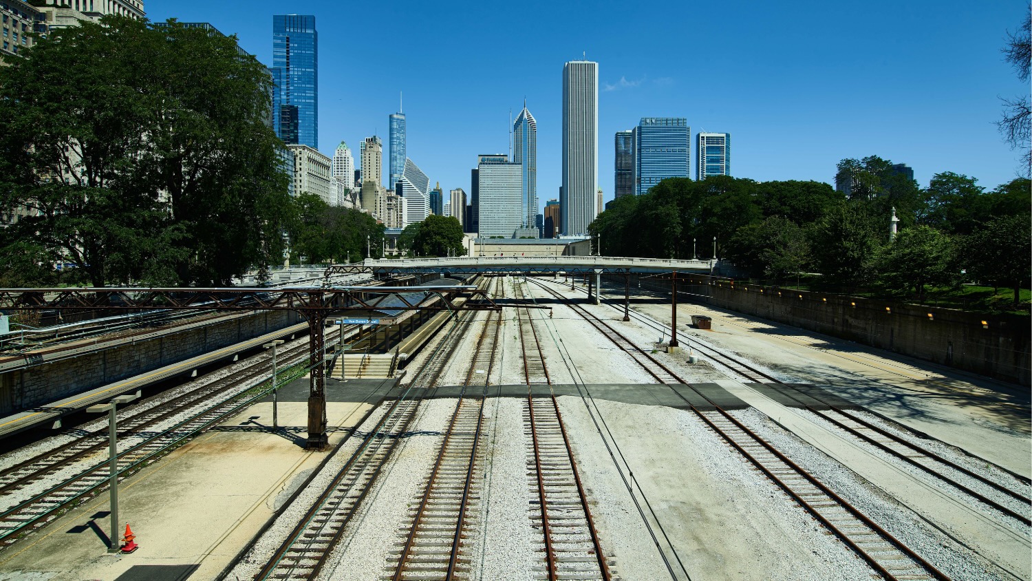 "Railroad tracks overlooking a city skyline"